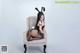 A woman in a bunny costume sitting on a chair.