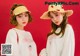 two young women wearing straw hats and white sweatshirts