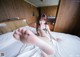 A woman laying on a bed with her feet up.